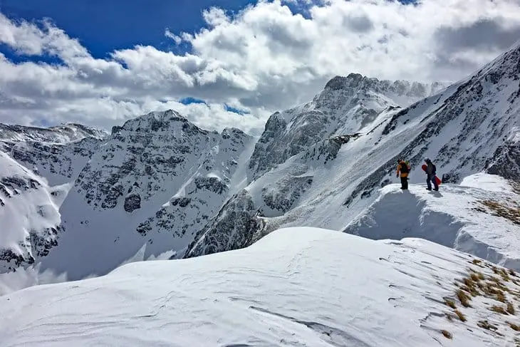 Expert snowboarders at Silverton Mountain, Colorado, one of the steepest ski areas in North America