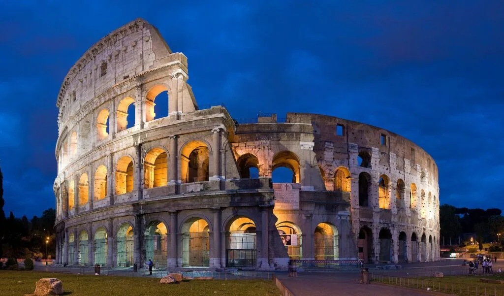 colosseum illuminated at dusk
