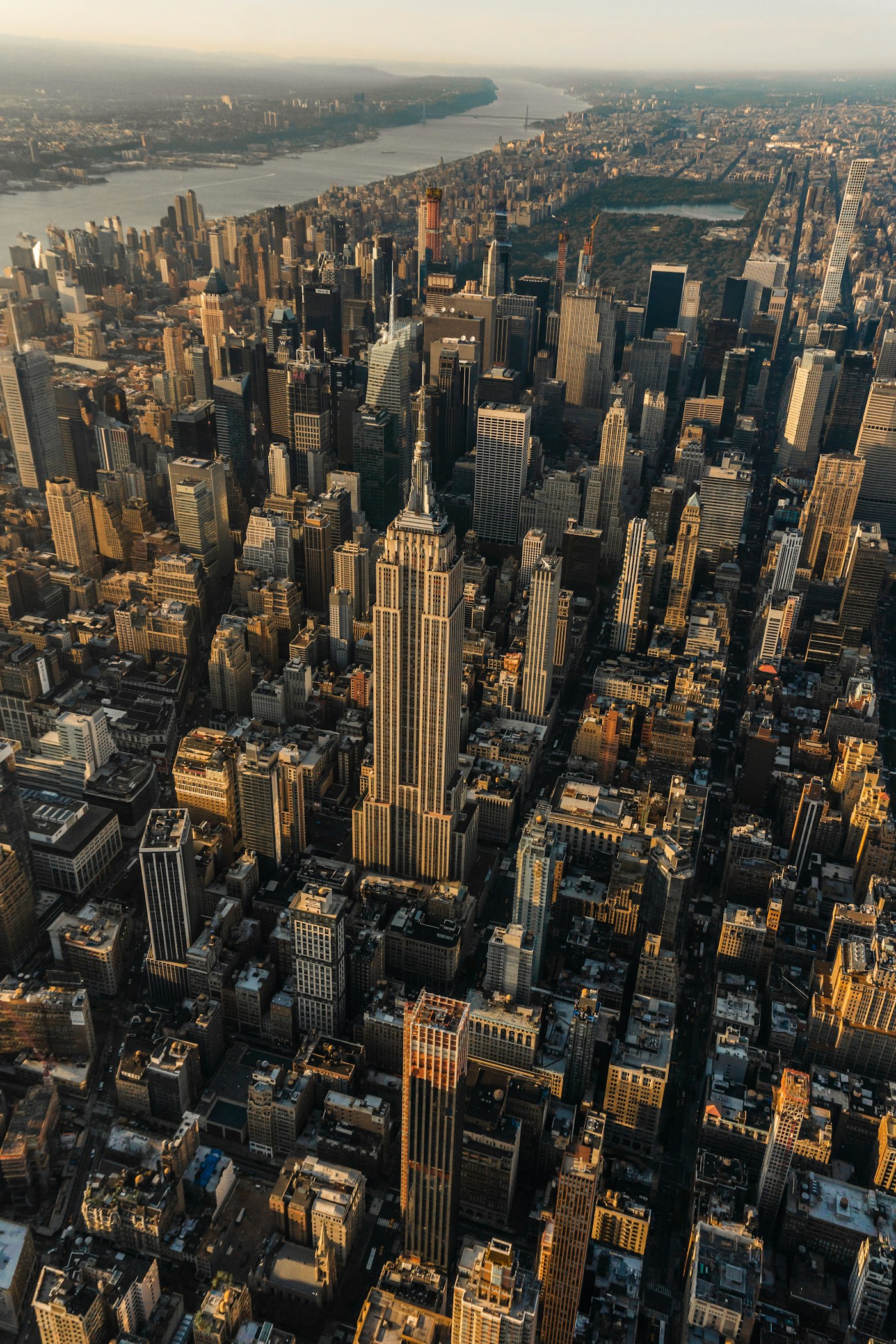 Manhattan skyline with skyscrapers and the Brooklyn Bridge at golden hour