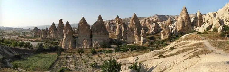 Wide panorama of the fairy chimney rock formations across the Cappadocia plateau