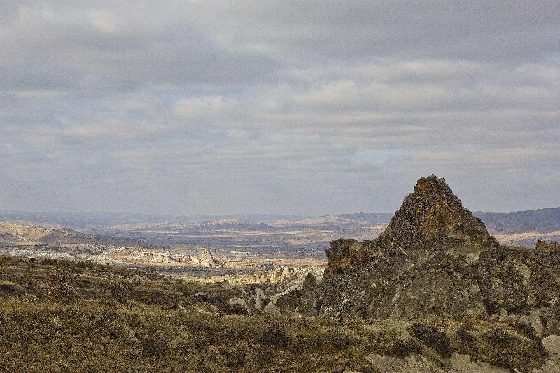 Hikers walking through the pink and red tuff rock formations of Rose Valley