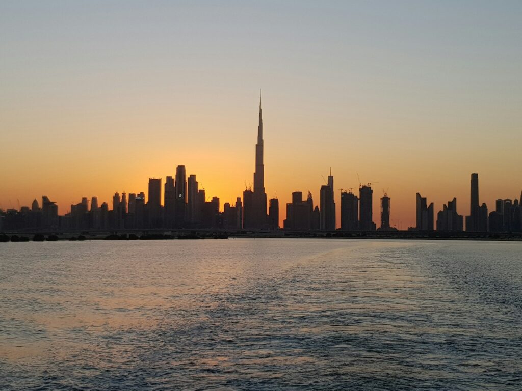 Dubai skyline at sunset with the Burj Khalifa and city lights