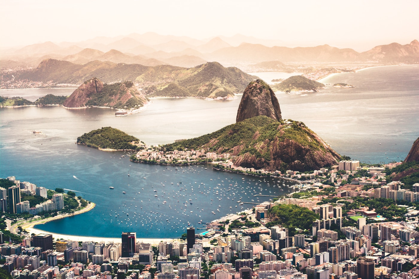 Panoramic view of Rio de Janeiro with Sugarloaf Mountain, Guanabara Bay, and city skyline at sunset