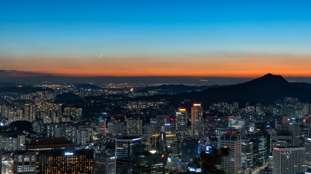 Seoul cityscape at night with the N Seoul Tower illuminated on Namsan Mountain and city lights spread below