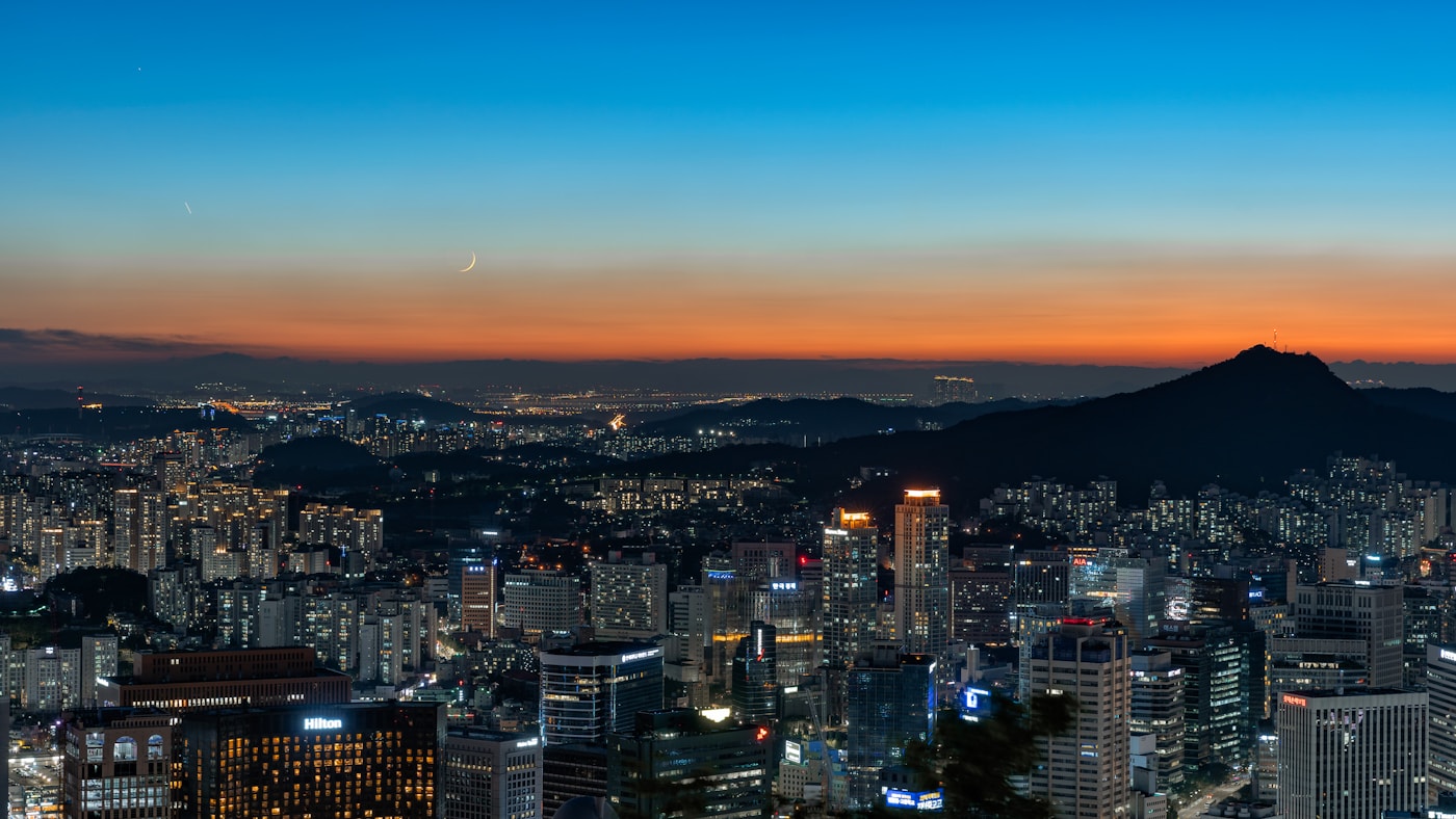 Seoul cityscape at night with the N Seoul Tower illuminated on Namsan Mountain and city lights spread below
