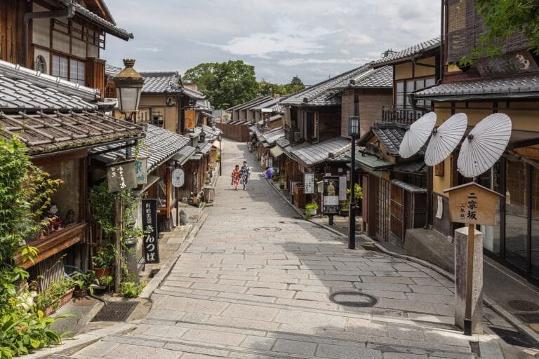 Sloping stone-paved lane lined with wooden machiya in Kyoto, Japan