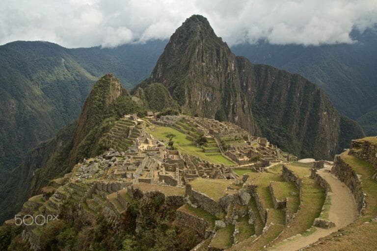 Machu Picchu's terraces under low cloud below Huayna Picchu, Peru