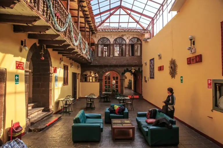 Glass-roofed colonial courtyard with seating in Cusco, Peru