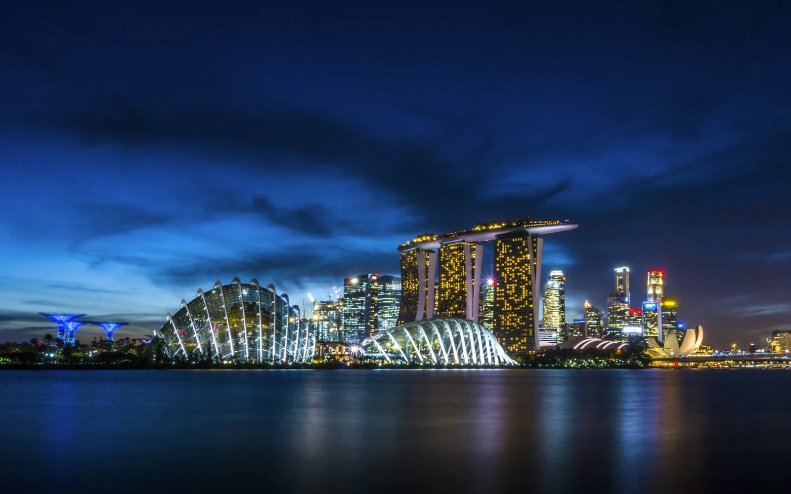 The illuminated Marina Bay skyline of Singapore at dusk