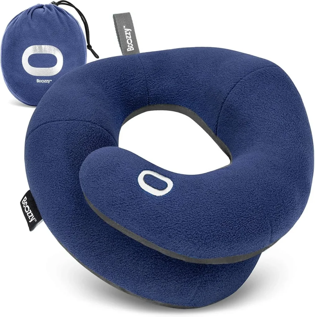 BCozzy contoured travel pillow in navy fleece with its round drawstring carry pouch.