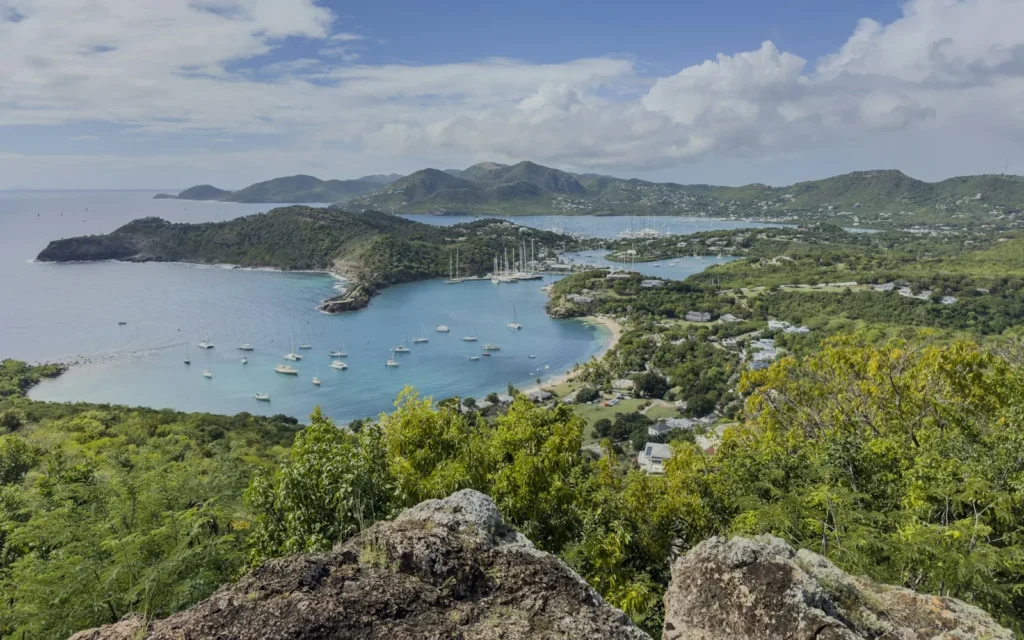Yachts anchored in a green-hilled harbour in Antigua