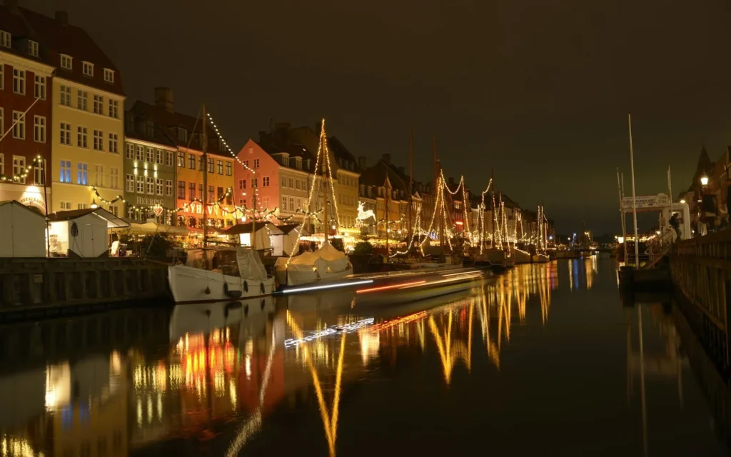 The colourful Nyhavn harbour of Copenhagen lit up at night, Denmark