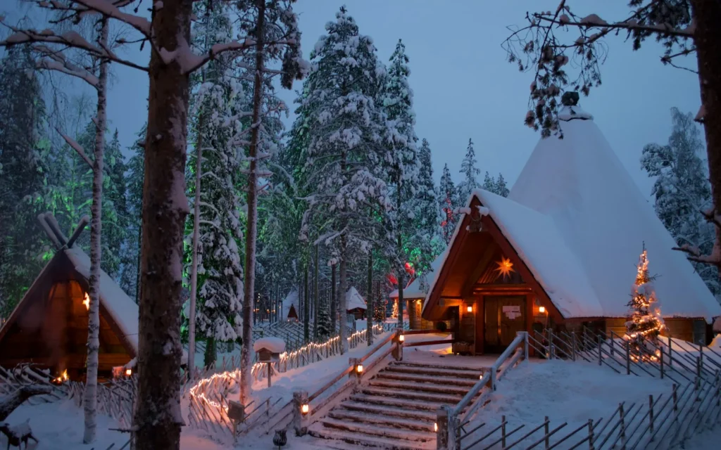 Snow-covered log cabins and Christmas lights in Rovaniemi, Finnish Lapland