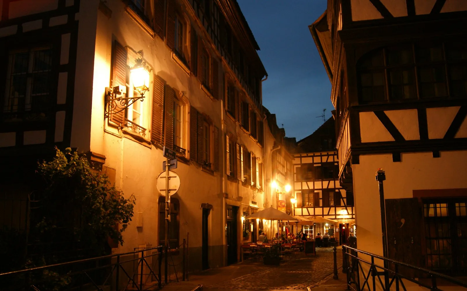 Festive lights on a half-timbered street in Strasbourg at night, France