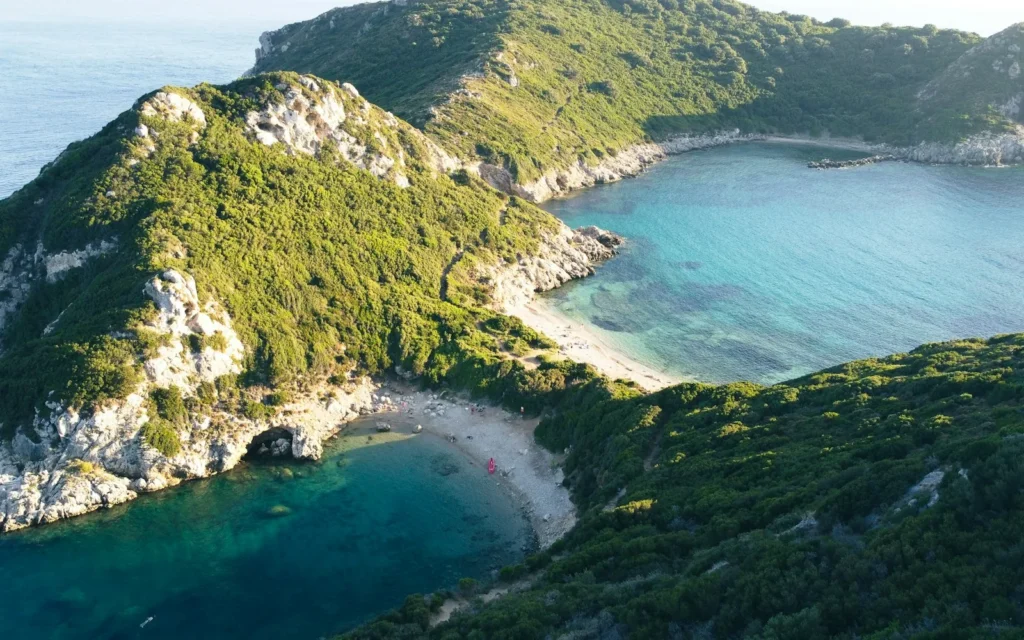 A green headland above a turquoise cove on Corfu, Greece