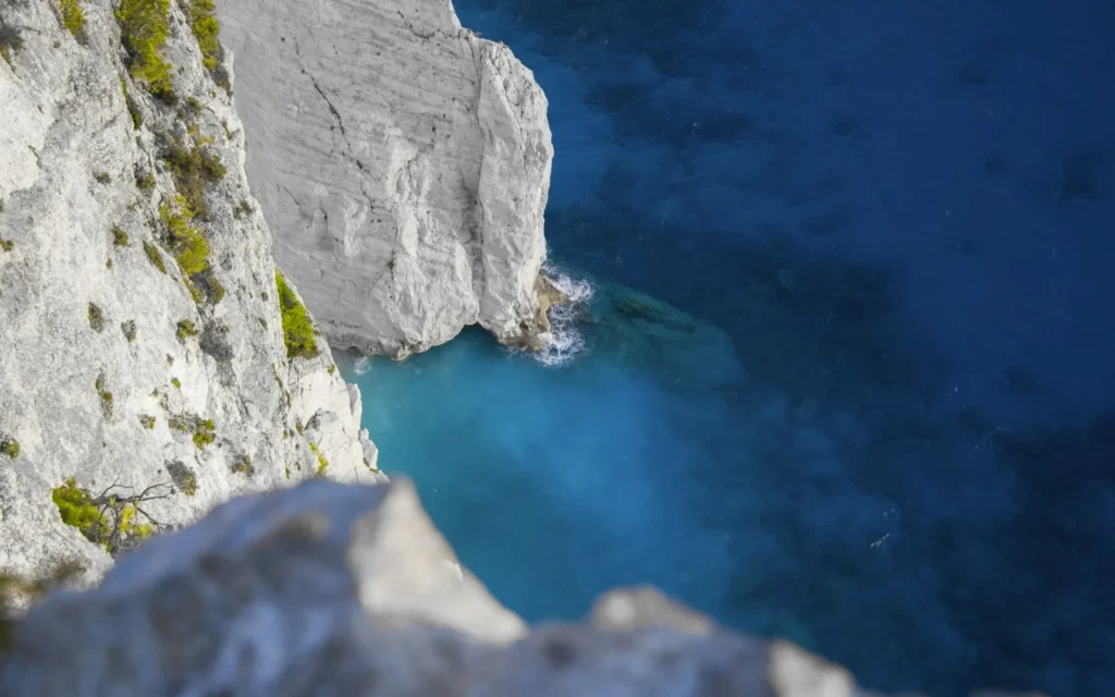 The white volcanic cliffs and blue sea of Milos, Greece