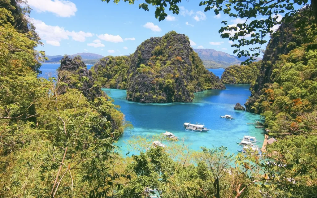 Boats on the karst-ringed Kayangan Lake at Coron, Palawan
