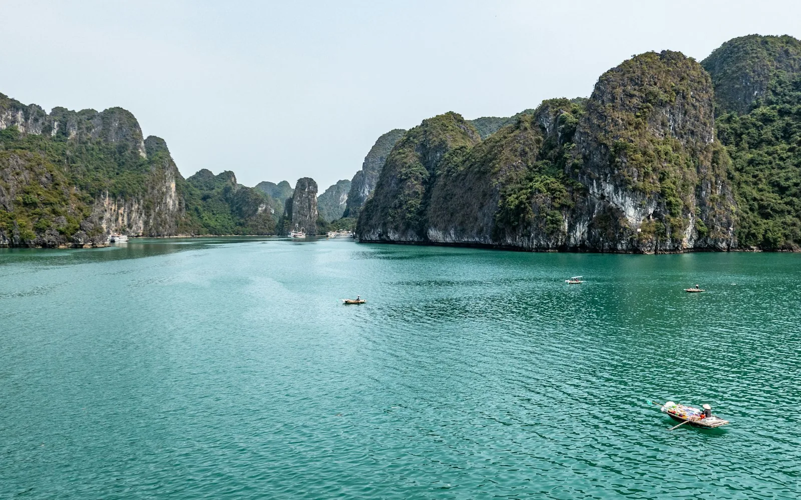 Limestone karsts rising from the emerald water of Ha Long Bay, <a href=