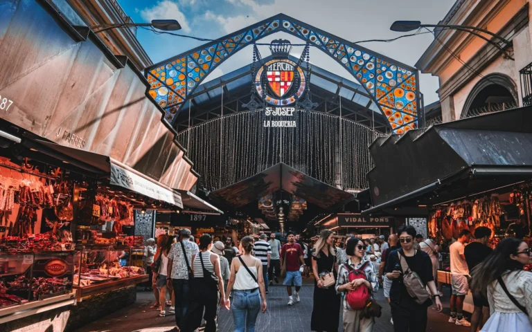 Shoppers among the produce stalls of La Boqueria market in Barcelona