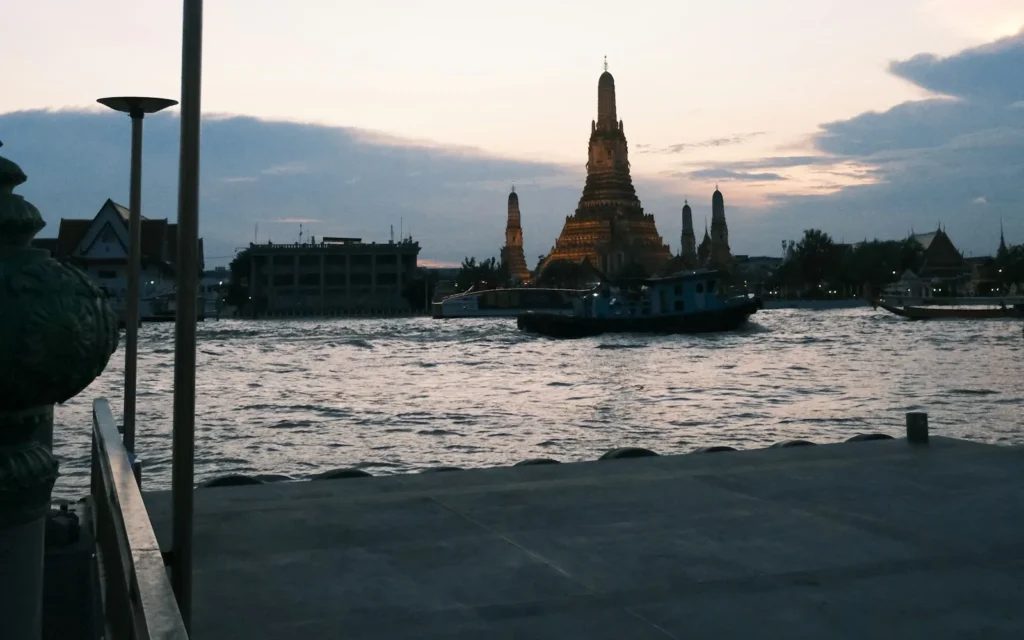 Wat Arun lit up on the Chao Phraya river in Bangkok