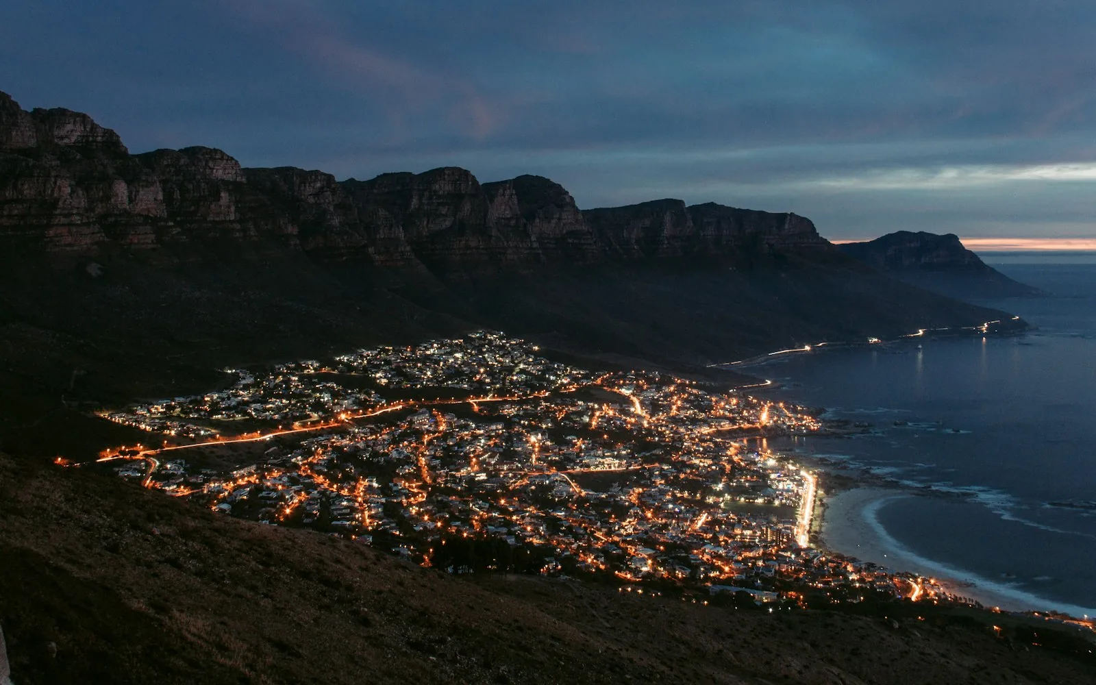 Cape Town glittering beneath Table Mountain at dusk, South Africa