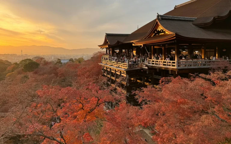 Kiyomizu-dera temple framed by fiery autumn maples in Kyoto, Japan