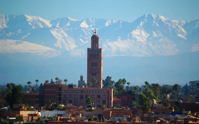 The Koutoubia Mosque and snow-capped Atlas Mountains above Marrakech, Morocco