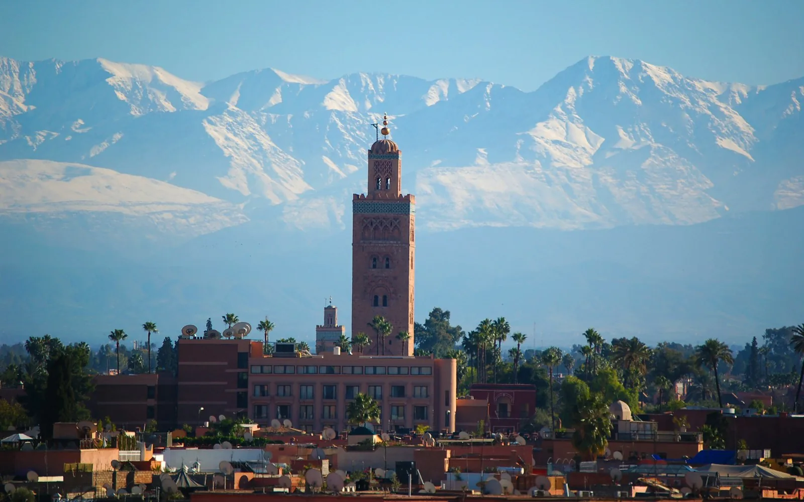 The Koutoubia minaret and Atlas Mountains above Marrakech, Morocco