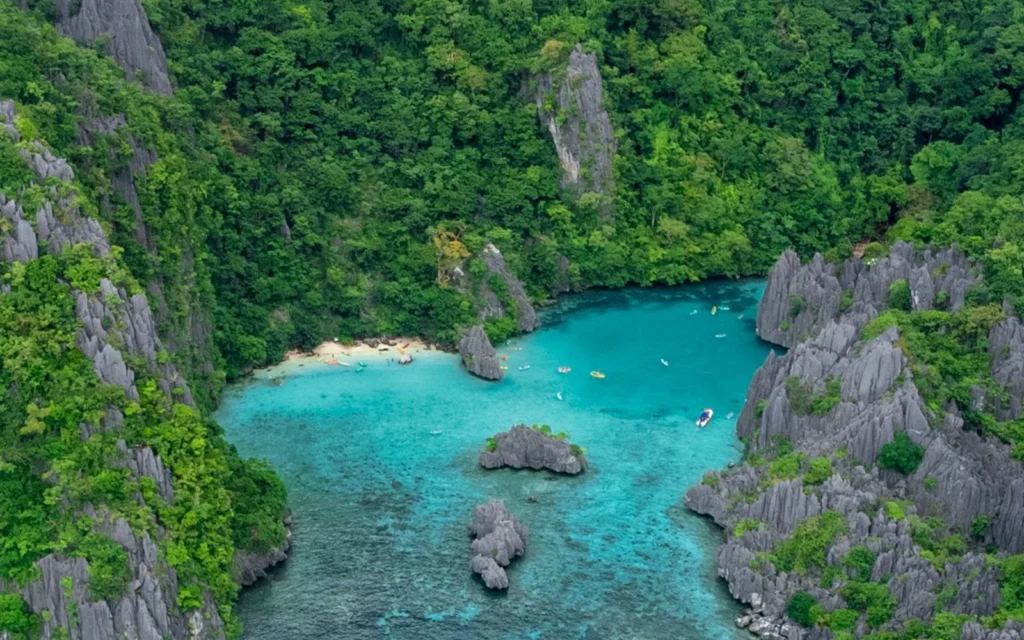 Boats in a karst-ringed lagoon at El Nido, Palawan