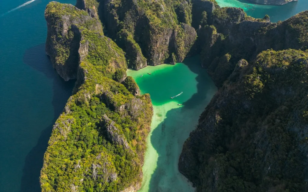 Limestone cliffs enclosing a turquoise lagoon at Koh Phi Phi, Thailand