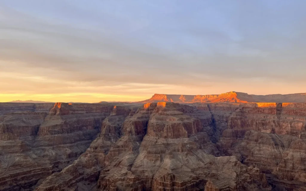 The sun setting over the layered buttes of the Grand Canyon South Rim, USA