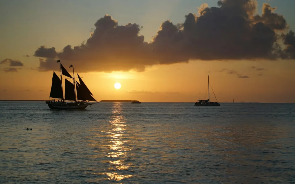 A tall-ship schooner silhouetted against the sunset off Key West, Florida