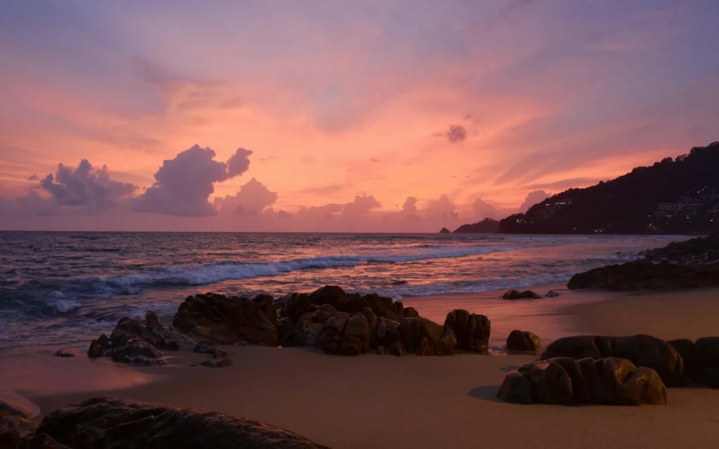 A pink sunset over the rocky cape and sea at Phuket, Thailand