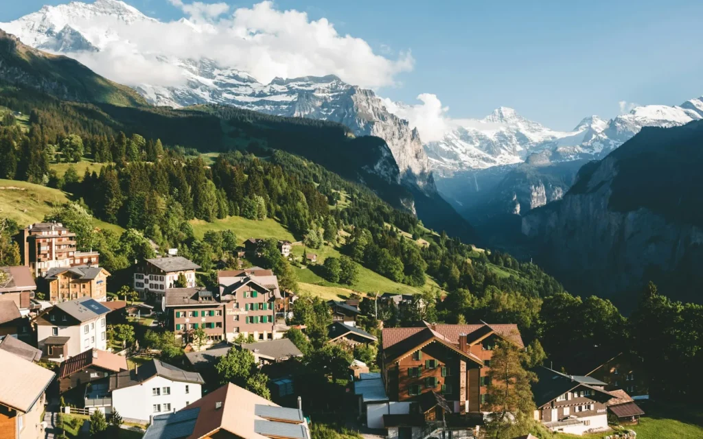 An alpine village below the snow-capped peaks of the Jungfrau region, Switzerland