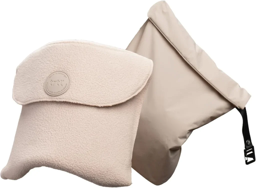 Trtl Pillow Plus in cream fleece, the adjustable neck wrap shown with its travel bag.