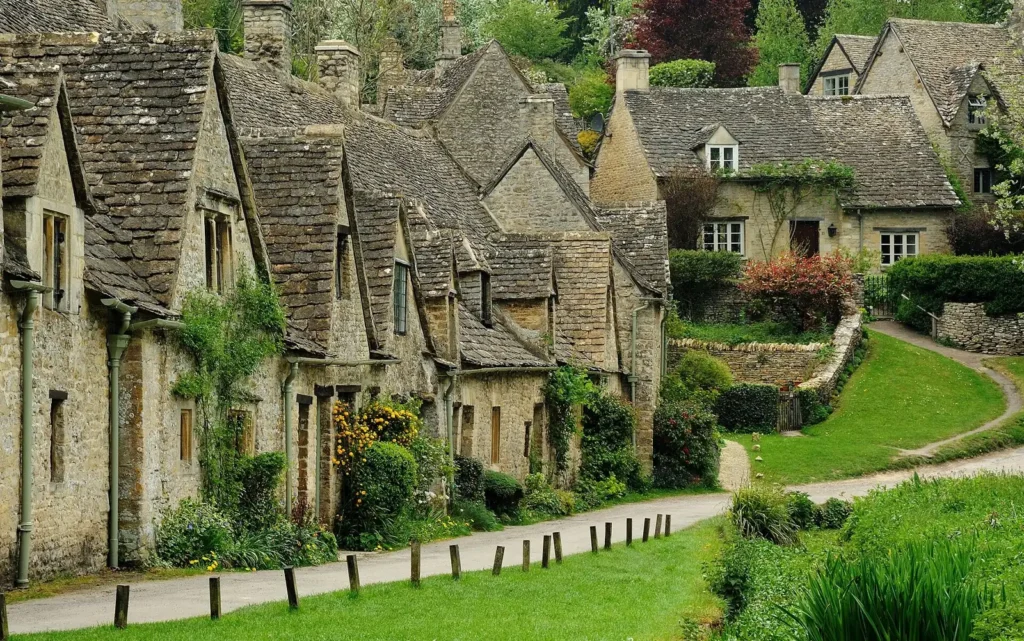 The honey-coloured stone cottages of Arlington Row at Bibury in the Cotswolds, England