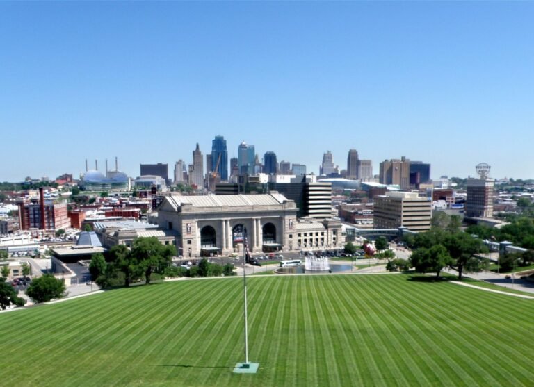 Kansas City’s downtown skyline rising behind Union Station and the long green lawn below the Liberty Memorial