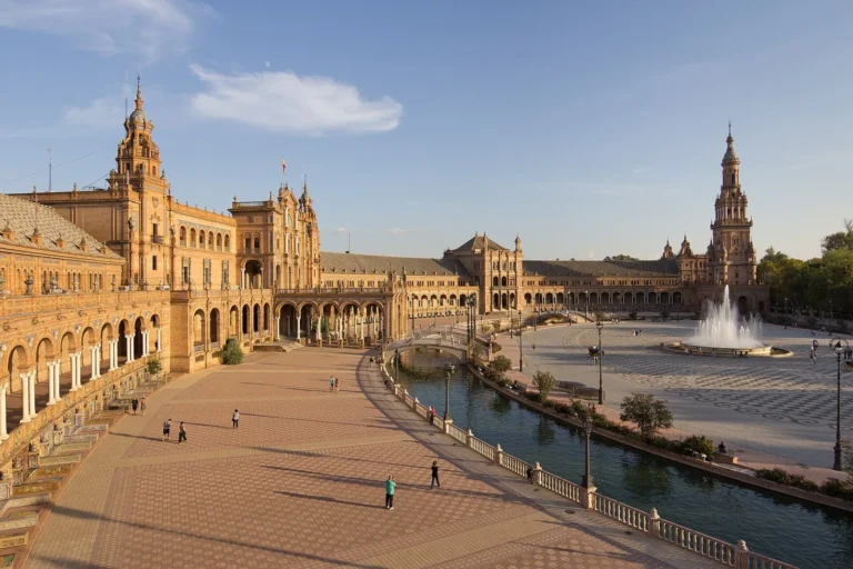 The curved brick arcades and canal of the Plaza de Espana in Seville, Spain