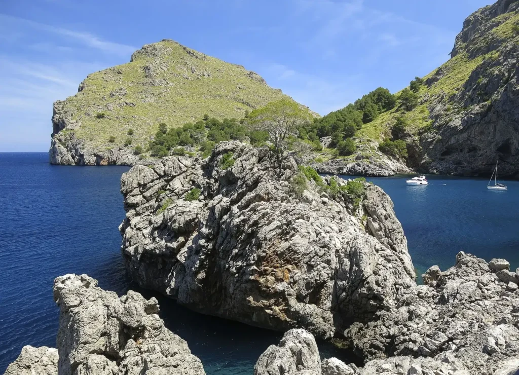 Limestone headland and a turquoise cove on the Serra de Tramuntana coast of Mallorca, Spain