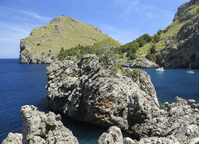 Limestone headland and a turquoise cove on the Serra de Tramuntana coast of Mallorca, Spain
