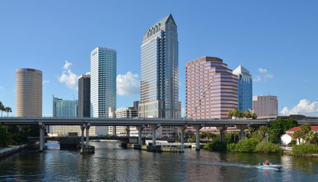 Downtown Tampa’s skyline above the Hillsborough River, with a road bridge crossing in the foreground